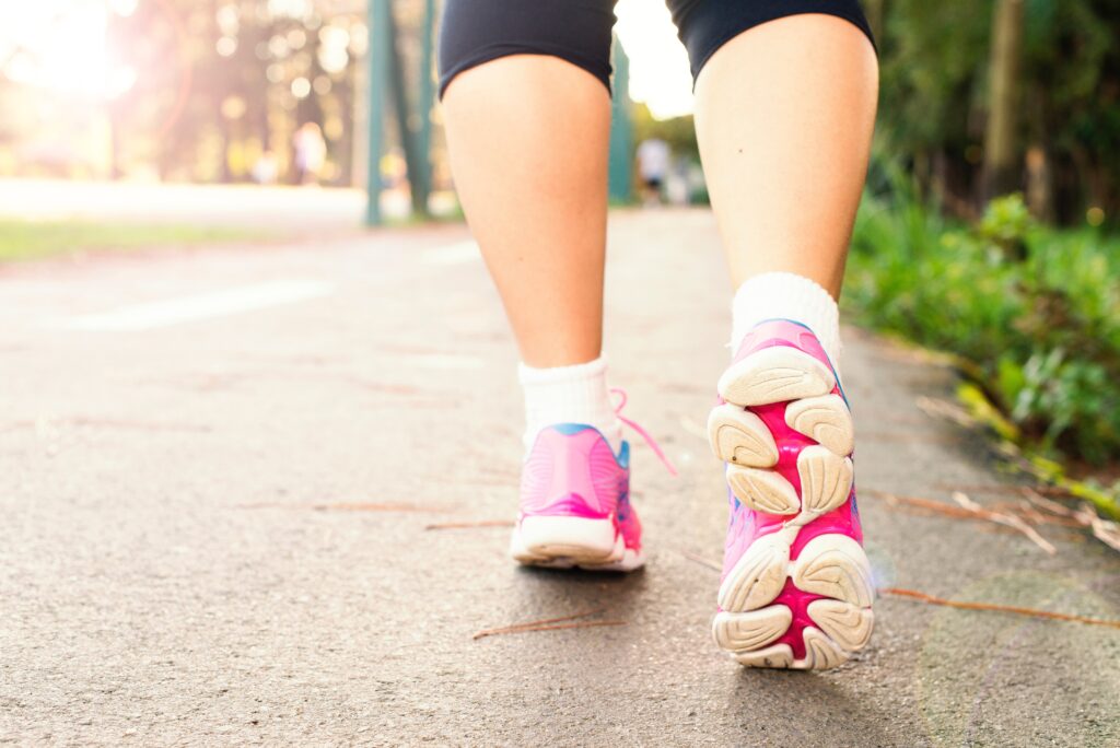 The legs and trainers of a runner