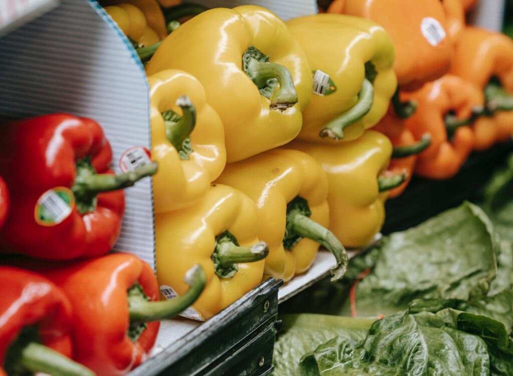 A market stall selling peppers and spinach